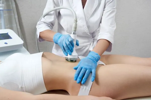Lost the Weight but Not the Loose Skin? 2 woman having HIFU treatment on her stomach to combat loose skin Cardiff following weight loss